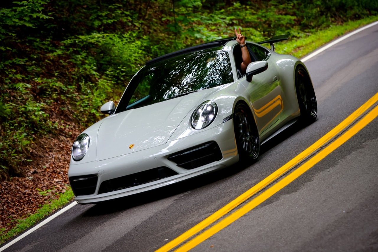 Alex's Chalk 2020 Porsche 911 Carrera S driving on a winding road